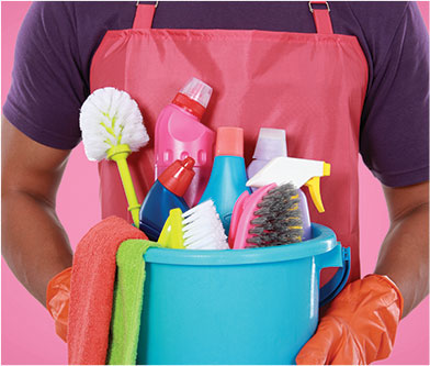 photo of a cleaner holding a bag of cleaning tools and liquids