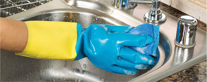 photo of a cleaner doing cleaning work on an oven