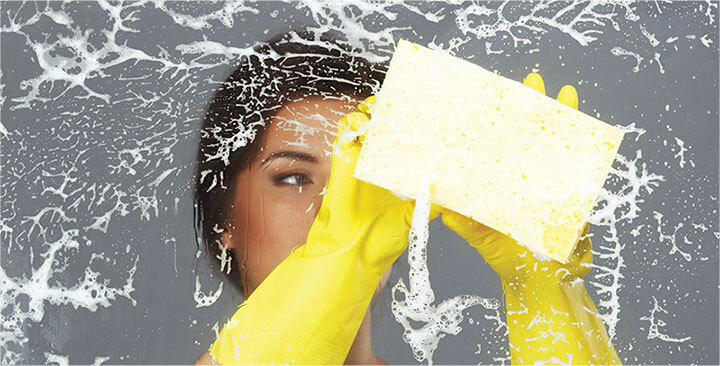 photo of a cleaner cleaning a dirty window